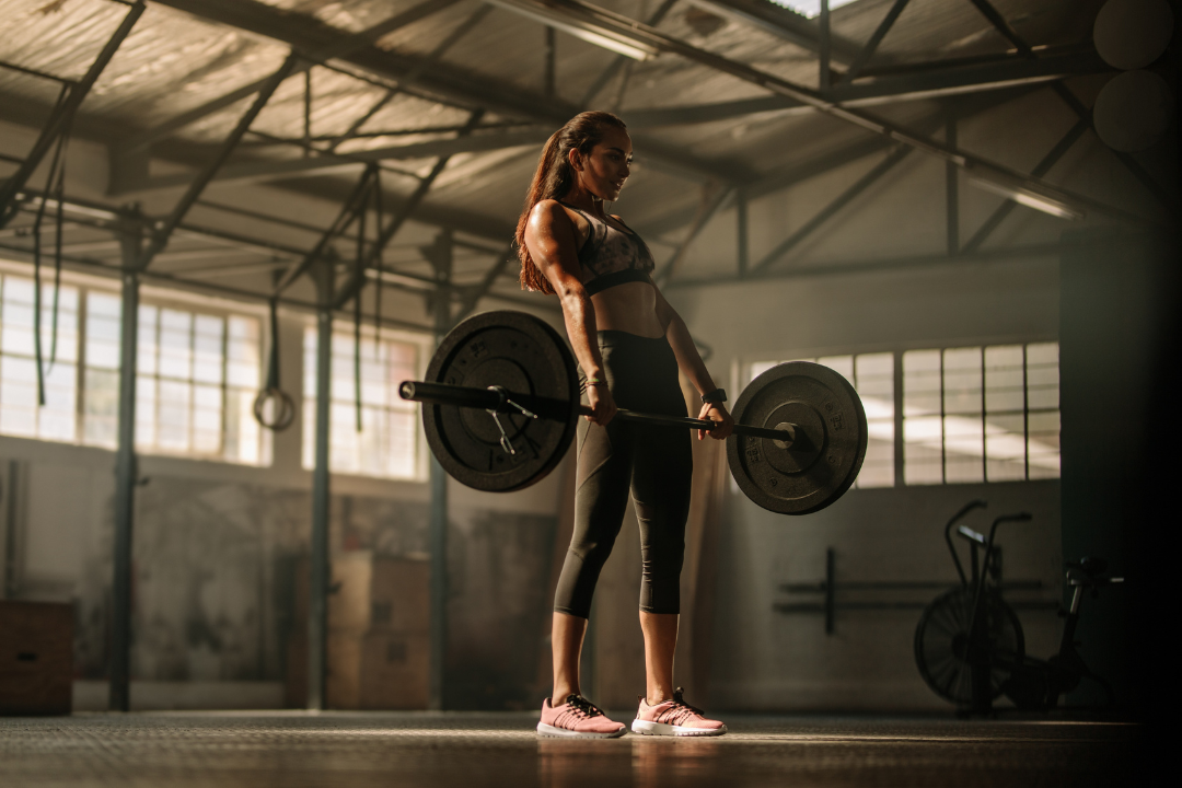 A woman performing a deadlift