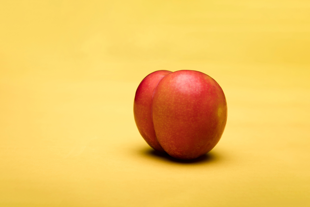 A peach against a yellow background